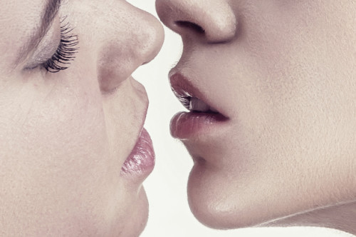 Close-up beautiful lesbian couple kissing on the lips